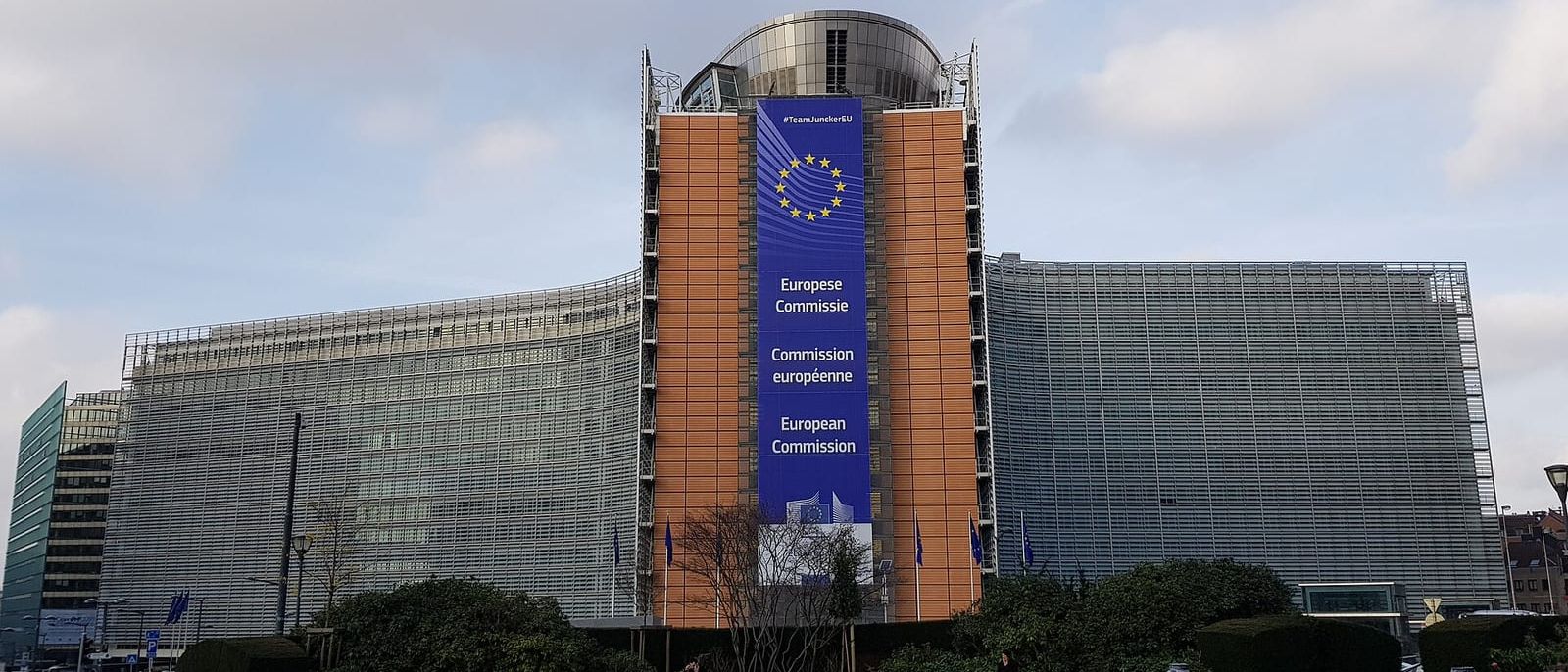 The European Commission's Berlaymont building in Brussels with a large EU banner on its facade