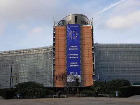 The European Commission's Berlaymont building in Brussels with a large EU banner on its facade