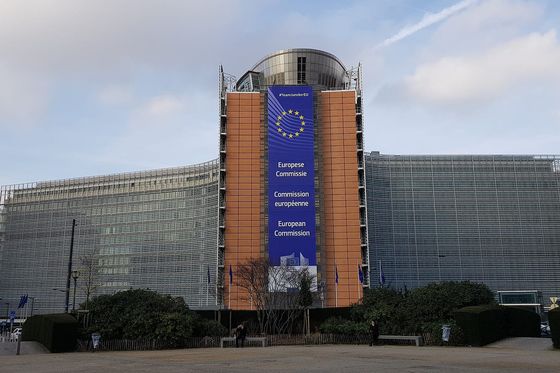 The European Commission's Berlaymont building in Brussels with a large EU banner on its facade