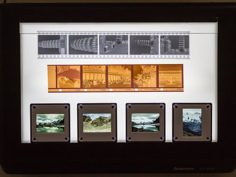 Black-and-white and colour film negatives and mounted slides on a lit light box